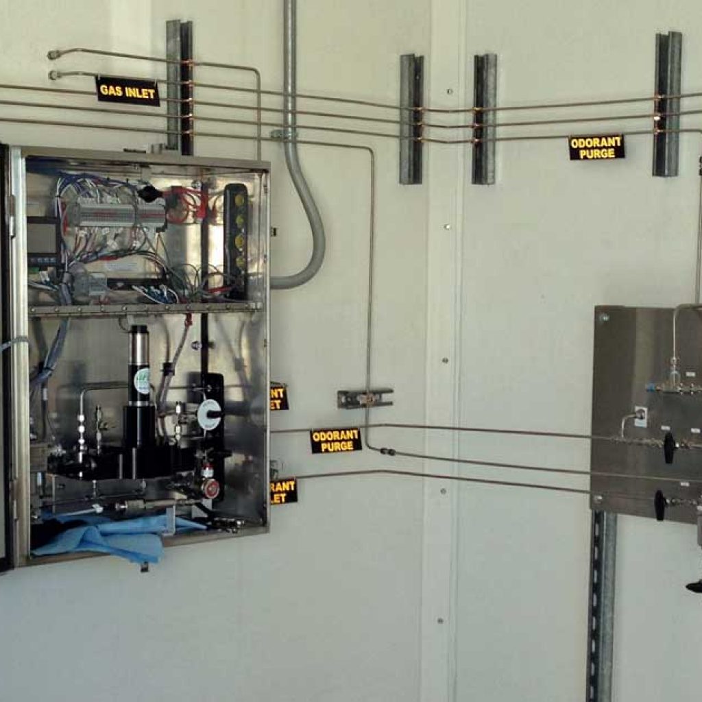 Inside a fiberglass building with odorization equipment